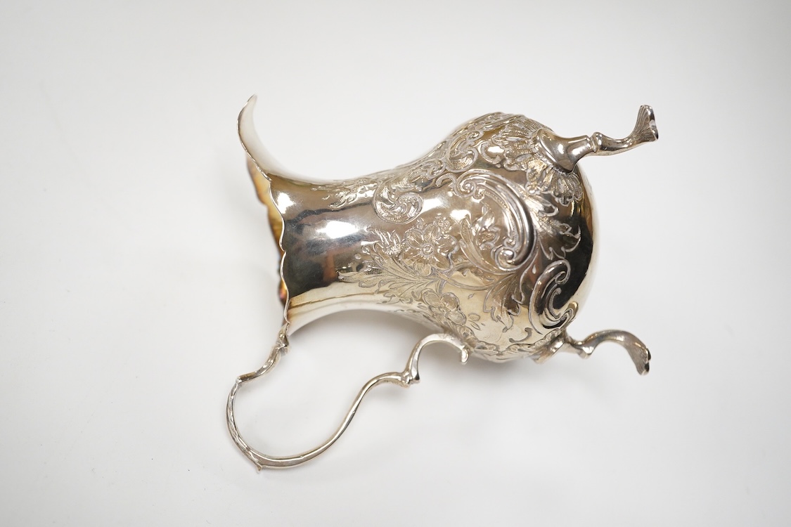A George II small silver cream jug by David Mowden, London, 1754, of baluster form, with later embossed decoration, height 99mm, 79 grams.
